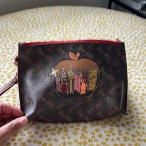 New**Coach wristlet With New York Apple in glitter.